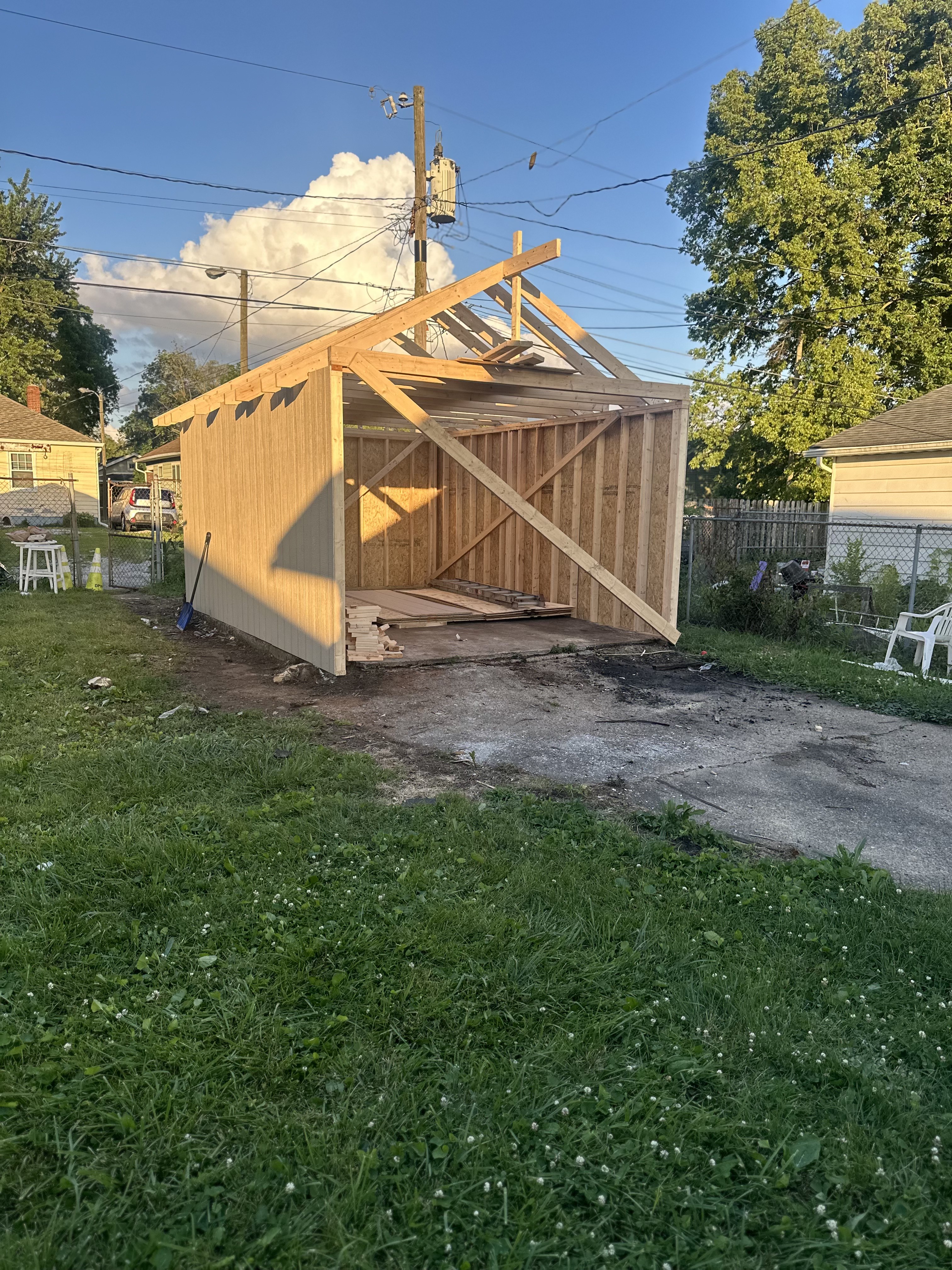 Detached Indianapolis garage under construction with exposed wood stud walls and open rafters before siding and roofing
